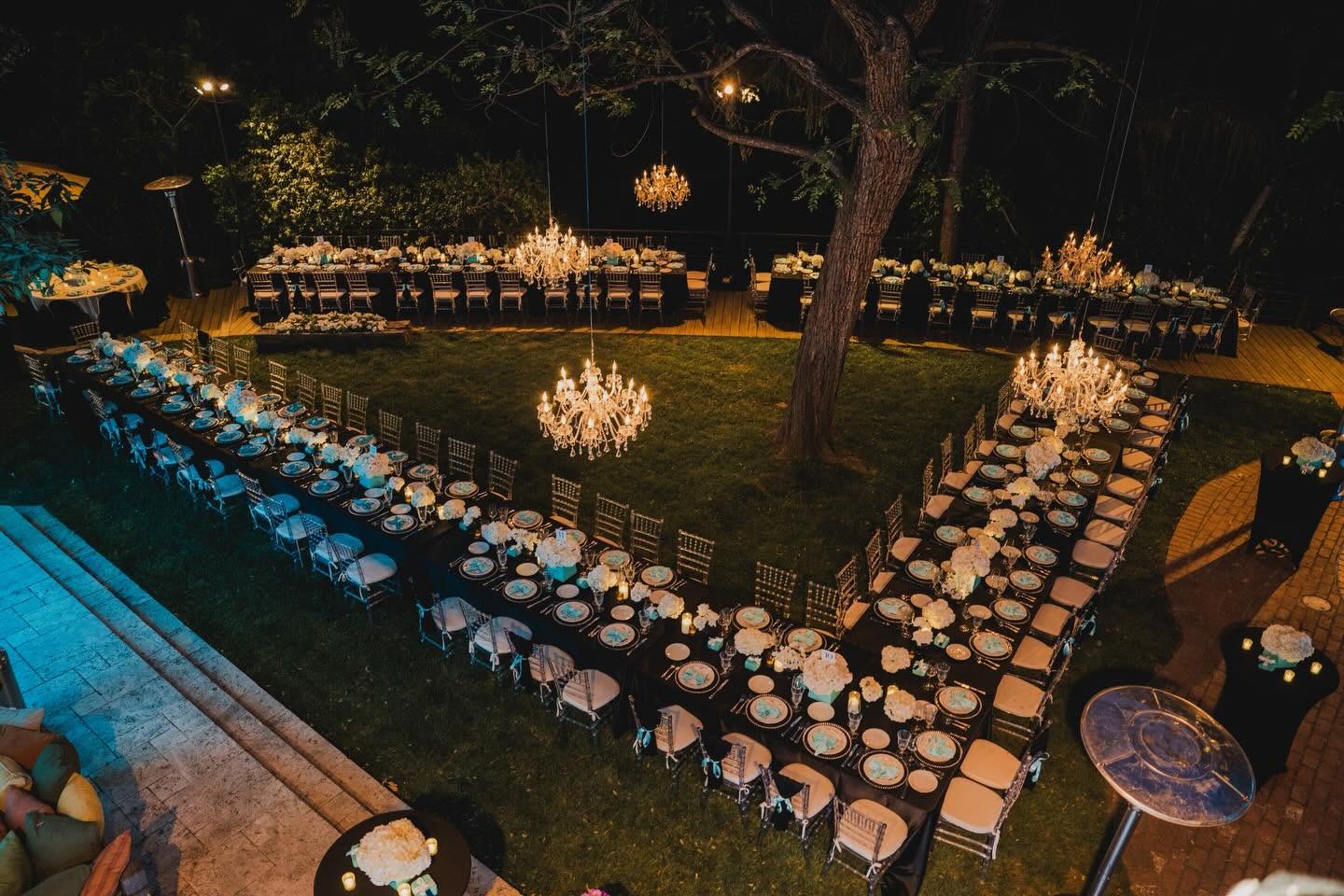 Tiffany-themed estate dinner with chandeliers and floral tablescapes