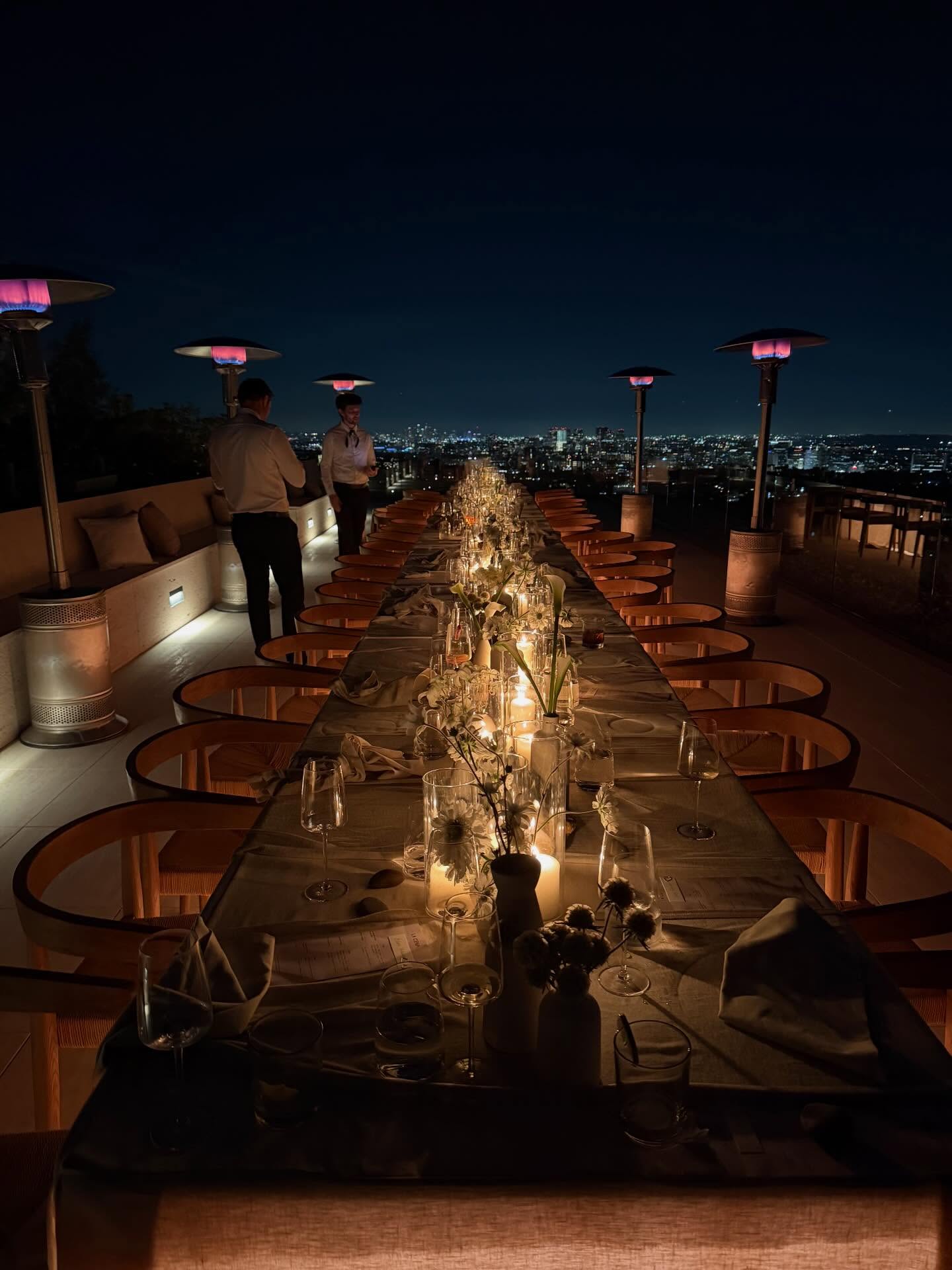 Candlelit rooftop dinner service above the Los Angeles skyline